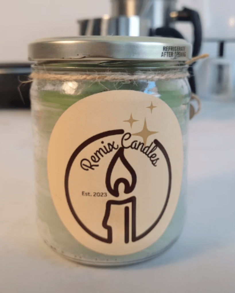 Light green candle with Remix Candles label on it